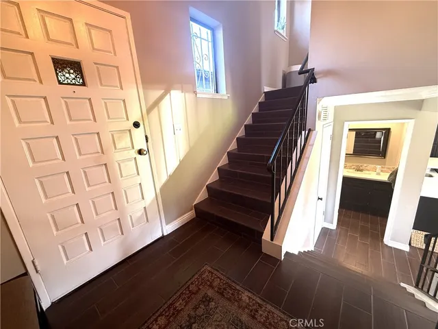 a view of entryway and hall with wooden floor