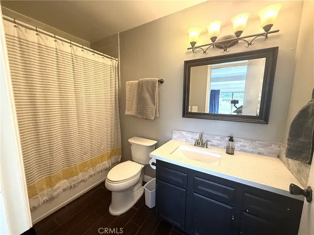 a bathroom with a toilet a sink and a mirror