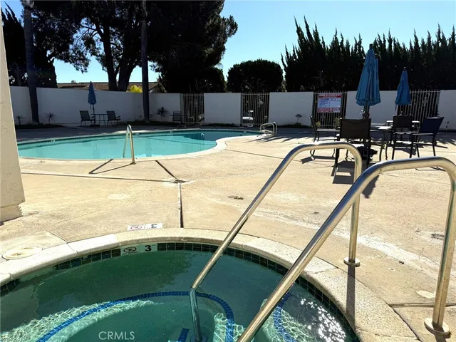 a swimming pool with some trees in the background