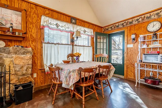 a dining room with furniture and wooden floor