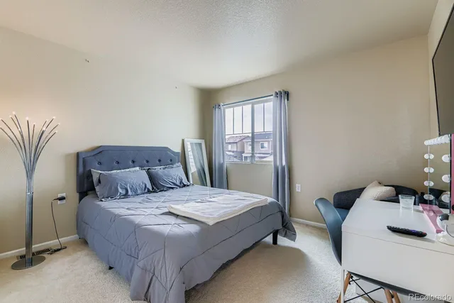 a bedroom with a bed and a table in it