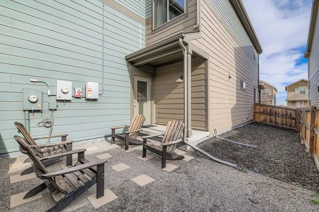 a view of a chairs and table in backyard