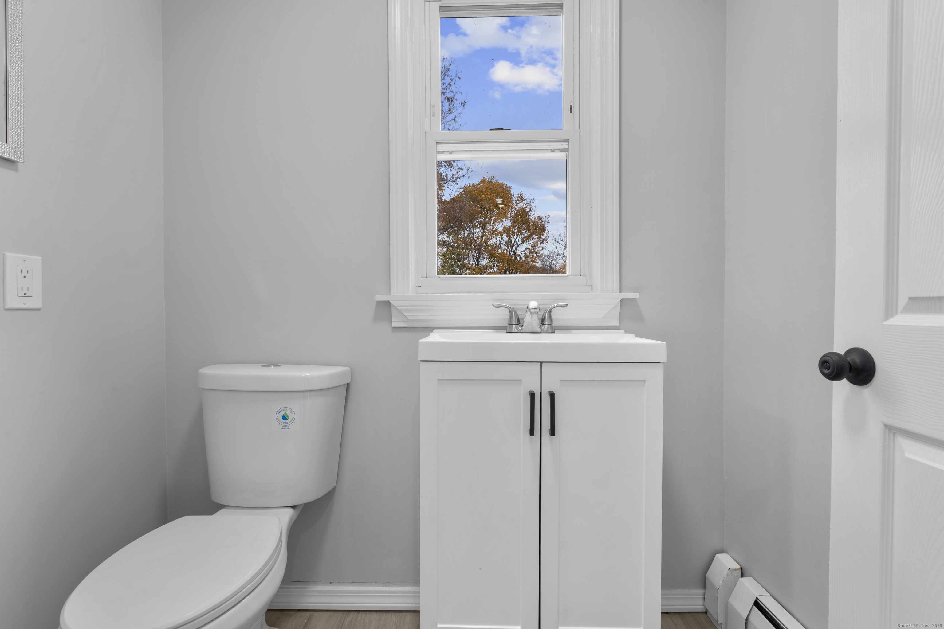 63 Irving Street Manchester, CT 06042 - Photo 16 of 39 a bathroom with a toilet sink and mirror