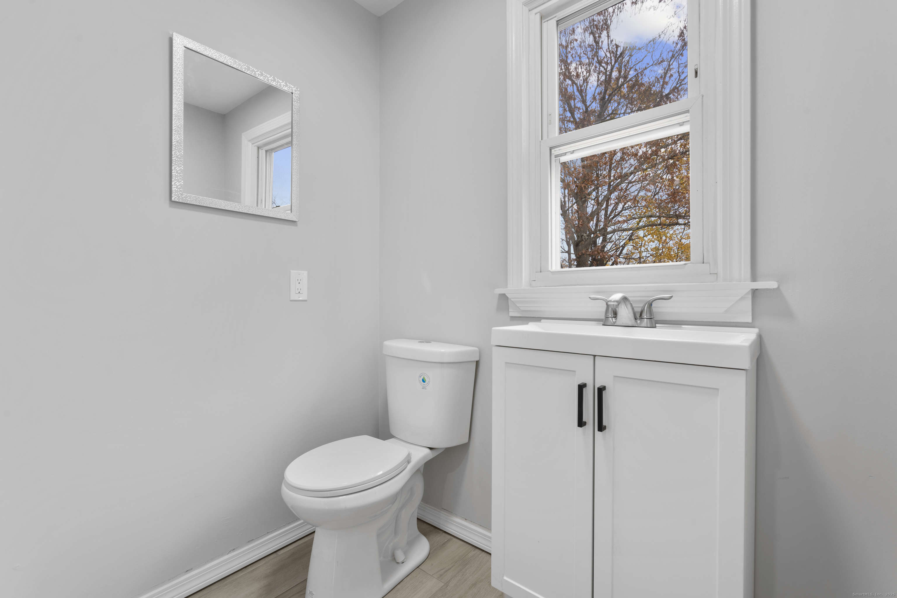 63 Irving Street Manchester, CT 06042 - Photo 17 of 39 a bathroom with a sink mirror and toilet