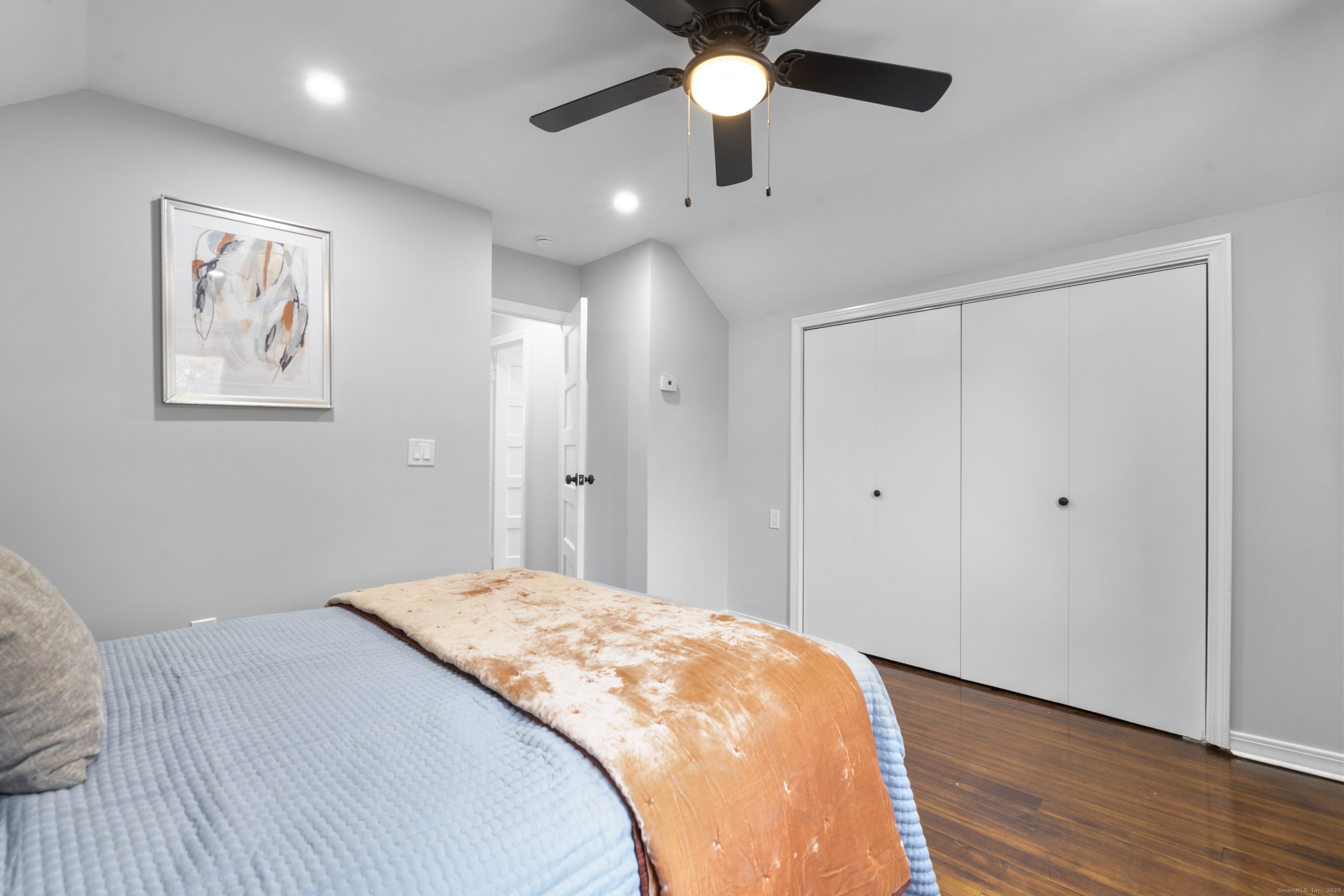 63 Irving Street Manchester, CT 06042 - Photo 21 of 39 a bedroom with a large bed and a chandelier