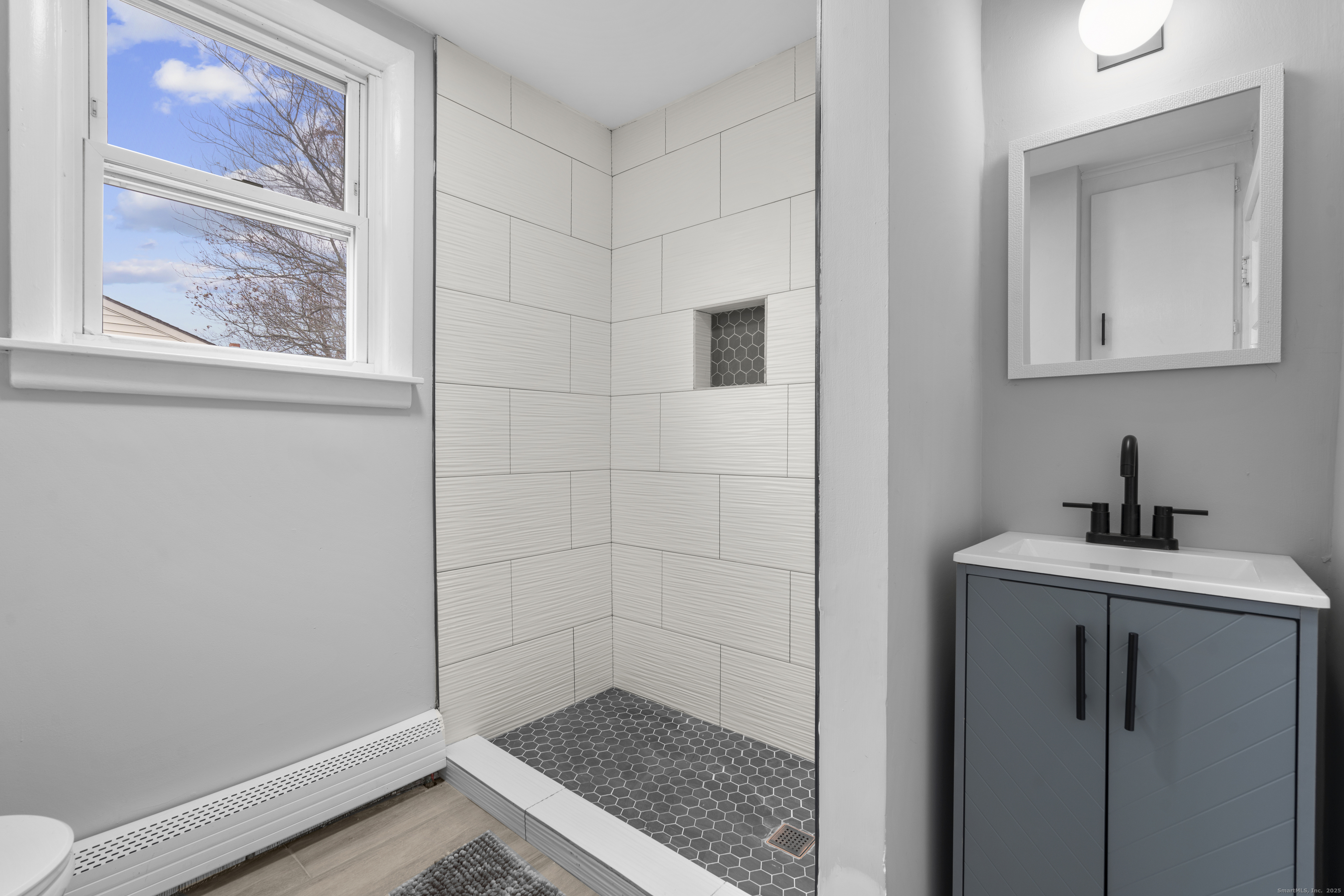 63 Irving Street Manchester, CT 06042 - Photo 27 of 39 a bathroom with a sink and a vanity