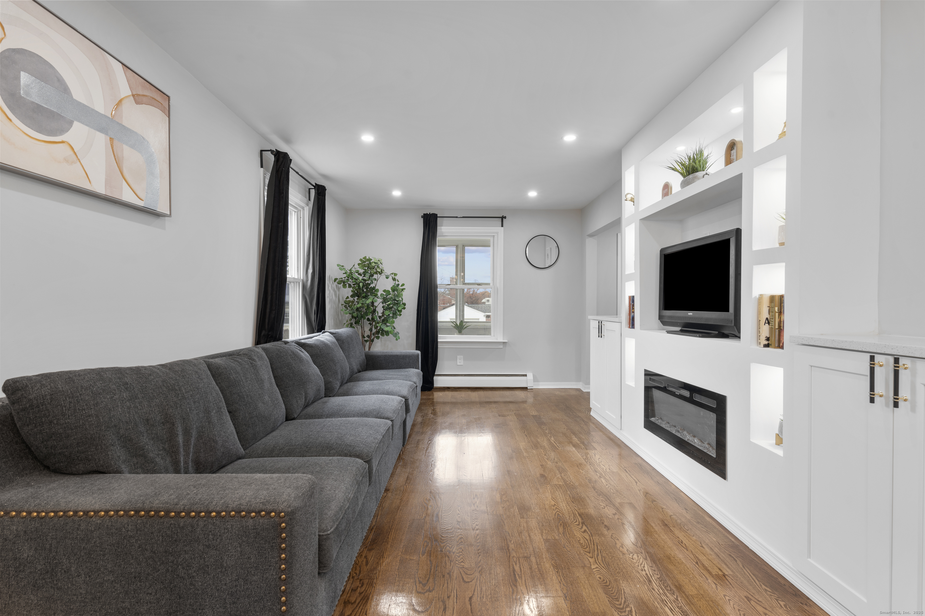 63 Irving Street Manchester, CT 06042 - Photo 7 of 39 a living room with furniture fireplace and flat screen tv