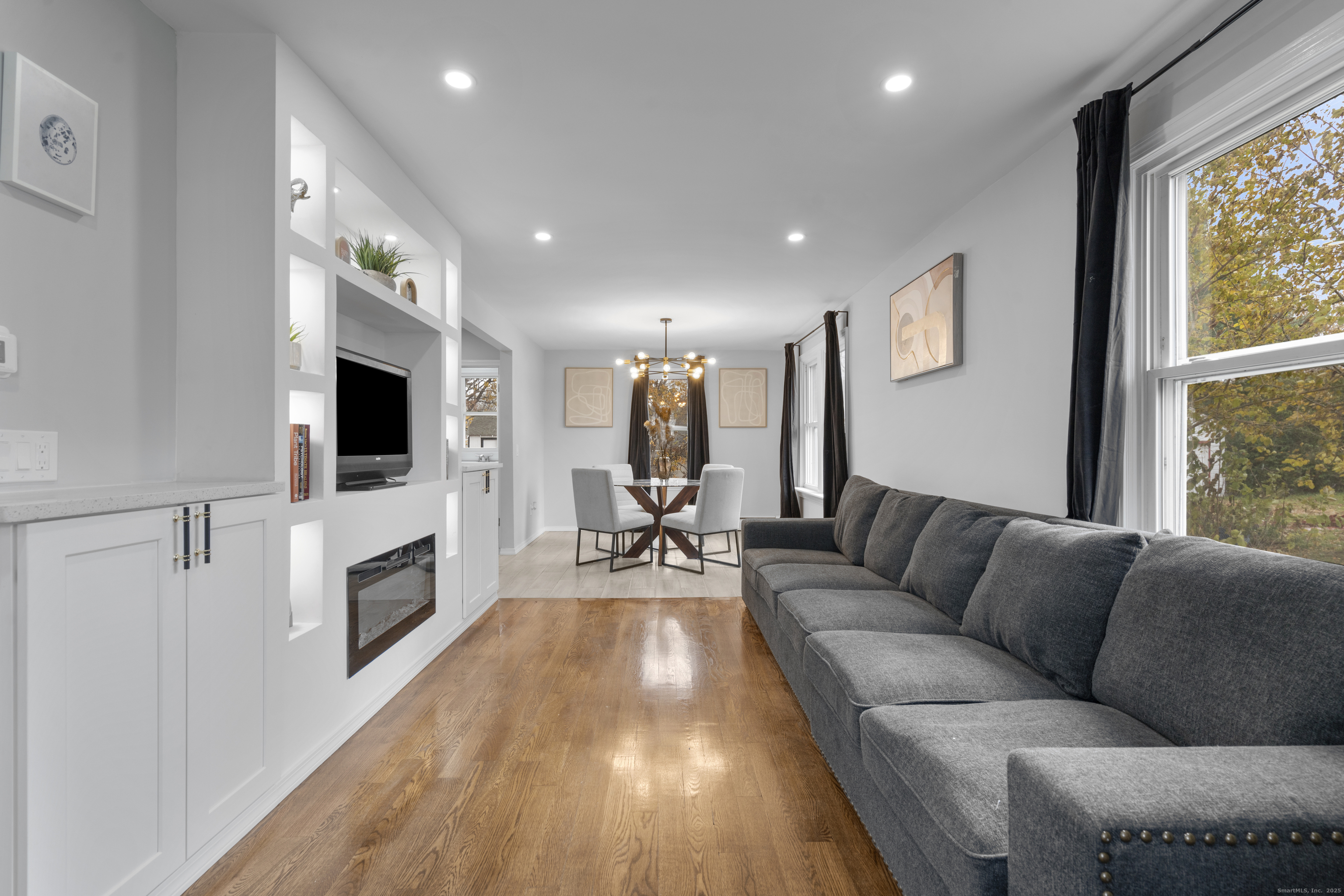 63 Irving Street Manchester, CT 06042 - Photo 8 of 39 a living room with fireplace furniture and a flat screen tv