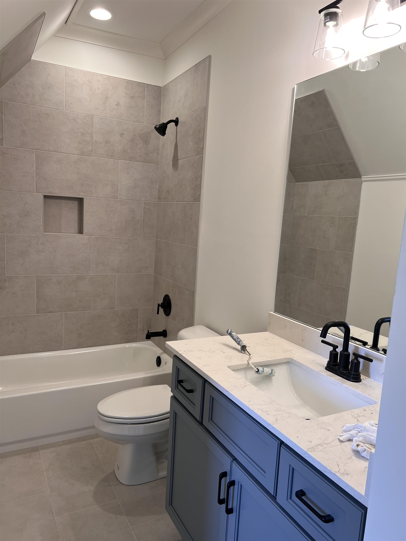 598 Cedar Shadows Circle West Collierville, TN 38017 - Photo 17 of 19 Full bathroom featuring tiled shower / bath combo, vanity, tile patterned floors, and toilet
