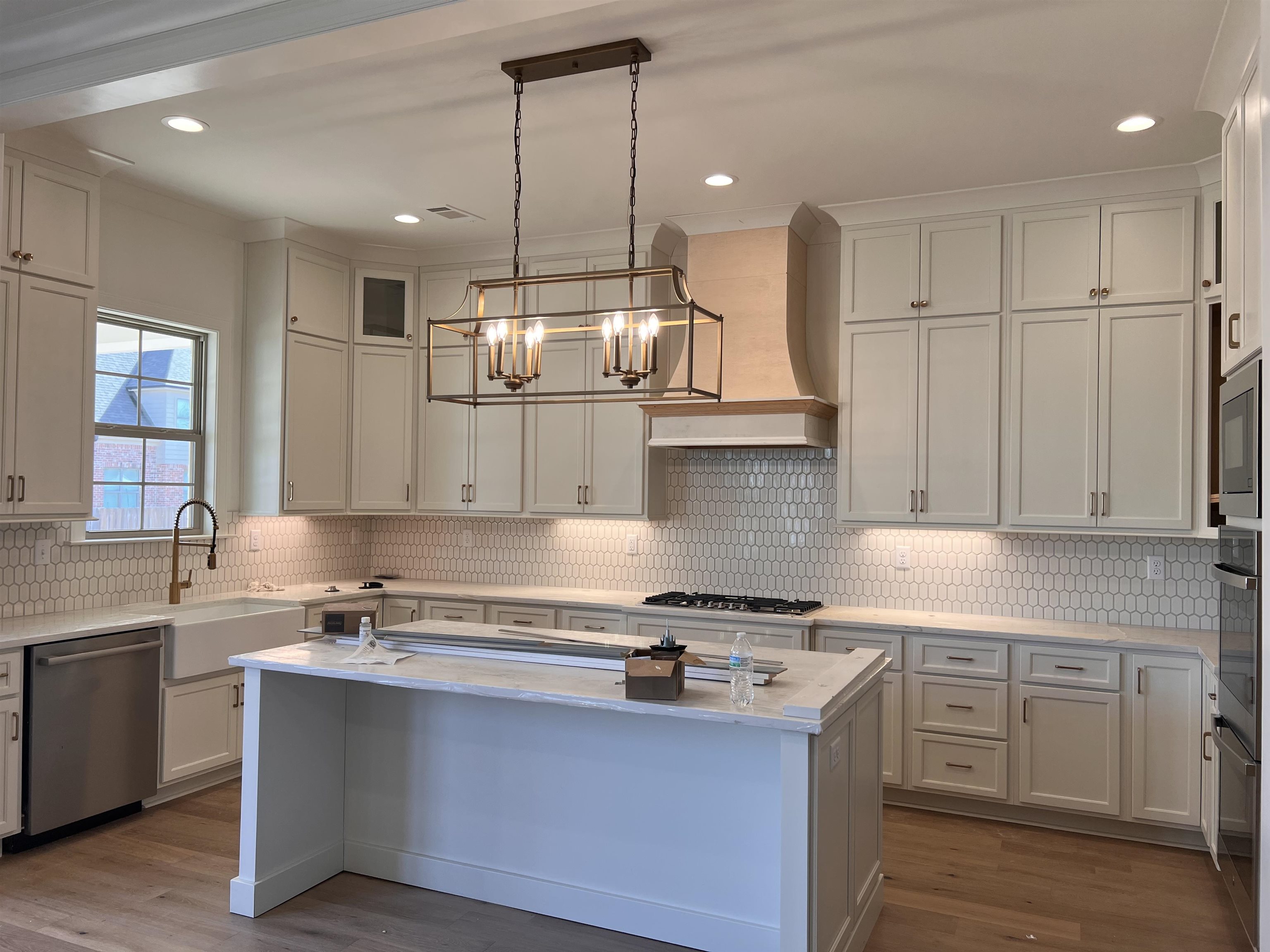 598 Cedar Shadows Circle West Collierville, TN 38017 - Photo 2 of 19 Kitchen with sink, custom exhaust hood, hanging light fixtures, a kitchen island, and stainless steel appliances