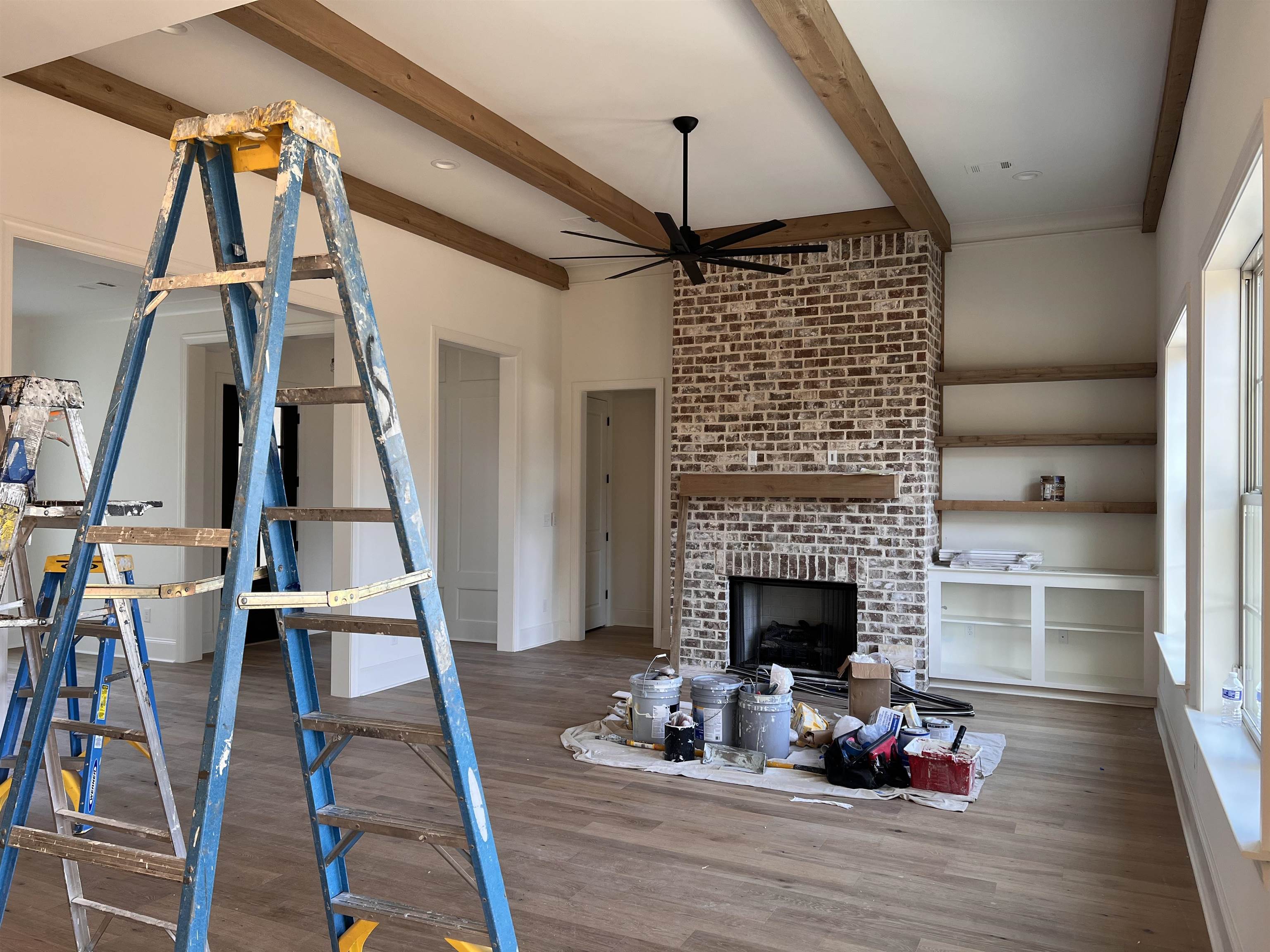 598 Cedar Shadows Circle West Collierville, TN 38017 - Photo 5 of 19 Unfurnished living room featuring cedar wood beam ceiling, wood flooring, a fireplace, and Built-In cabinetry