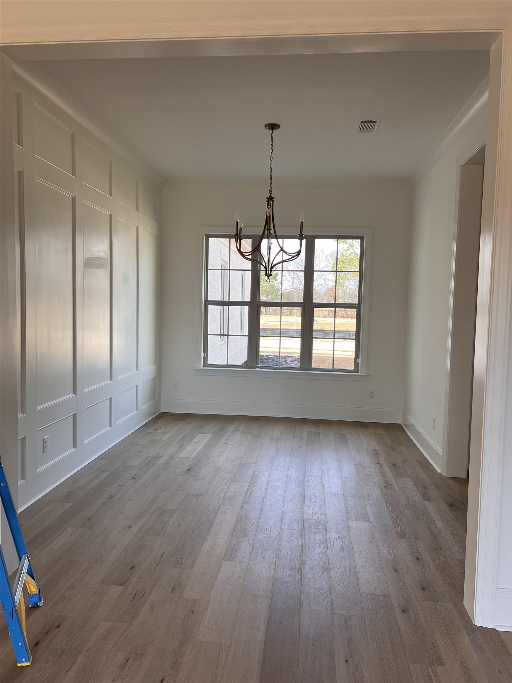 598 Cedar Shadows Circle West Collierville, TN 38017 - Photo 6 of 19 Unfurnished dining area featuring an inviting chandelier, hardwood flooring, and crown molding
