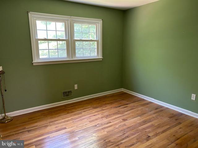484 Flock Road Hamilton, NJ 08619 - Photo 17 of 25 an empty room with wooden floor and windows