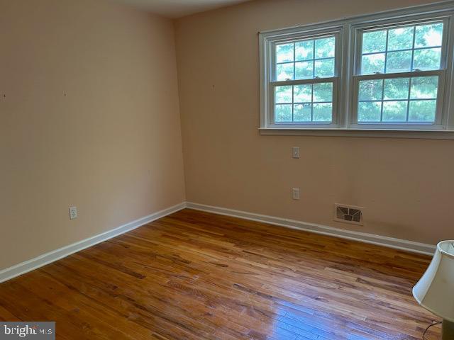 484 Flock Road Hamilton, NJ 08619 - Photo 18 of 25 an empty room with wooden floor and windows