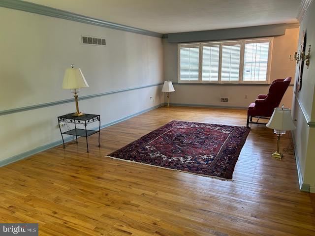 484 Flock Road Hamilton, NJ 08619 - Photo 5 of 25 a living room with wooden floor and a table