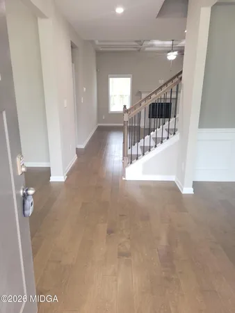 a view of kitchen with kitchen island white cabinets and stainless steel appliances