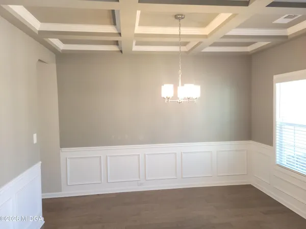 a kitchen with stainless steel appliances kitchen island granite countertop a sink a stove and a refrigerator