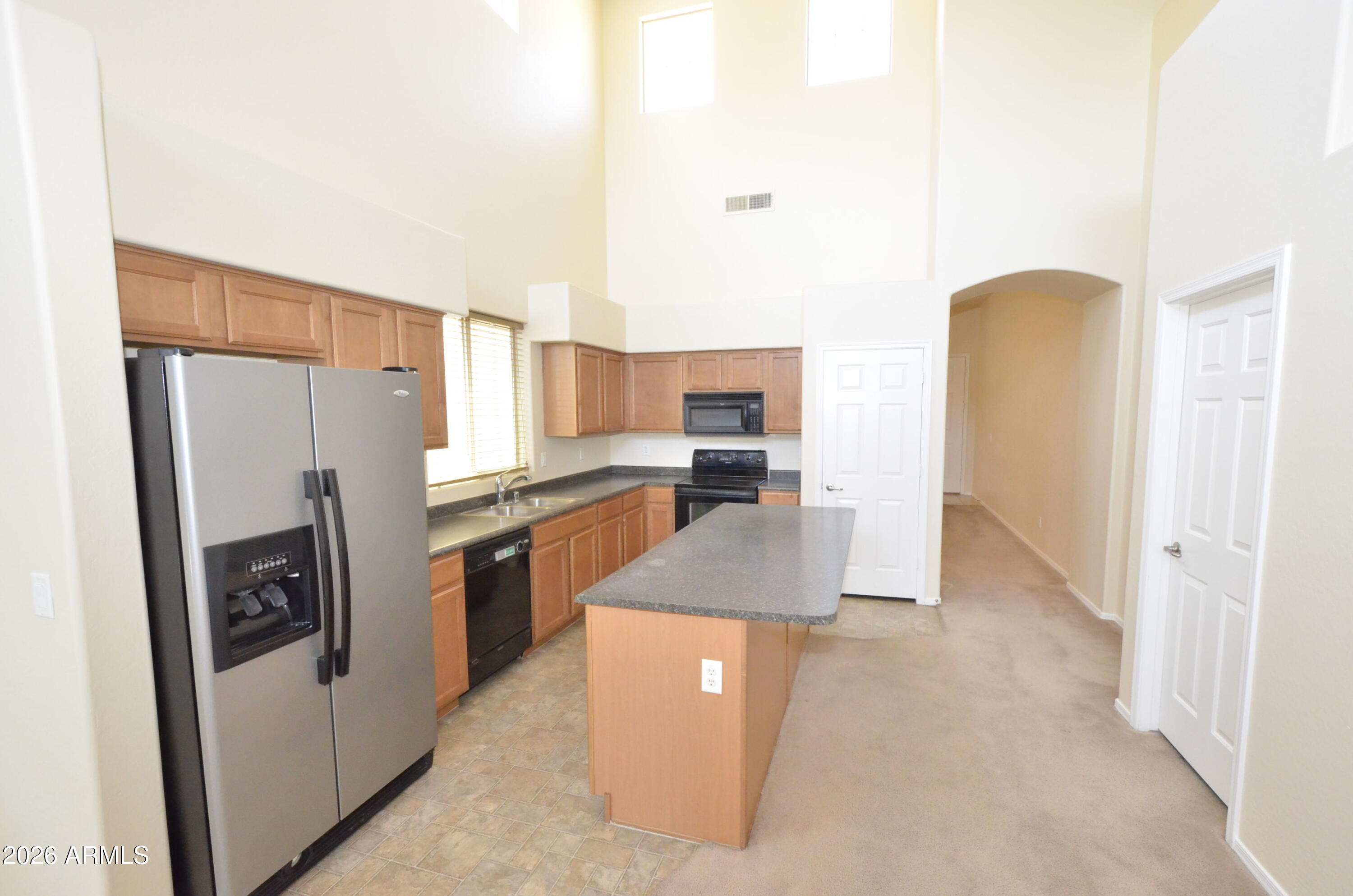 3995 East Trigger Way Gilbert, AZ 85297 - Photo 5 of 23 a kitchen with stainless steel appliances granite countertop a refrigerator a stove and a sink