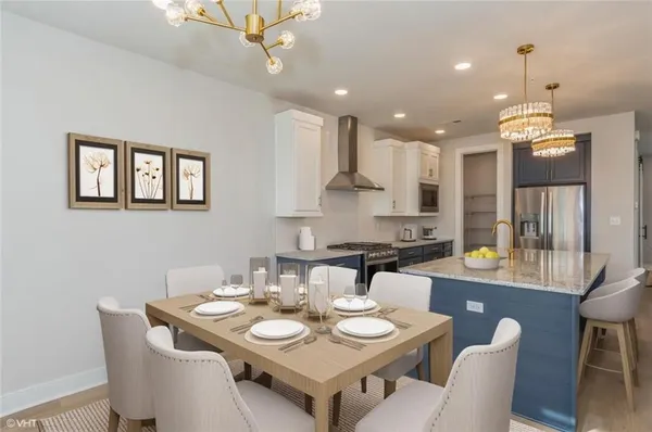 a kitchen that has a table and chairs in it