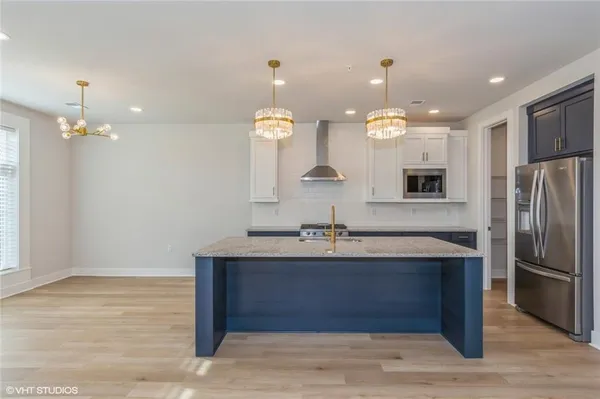 a bathroom with a sink mirror and cabinets