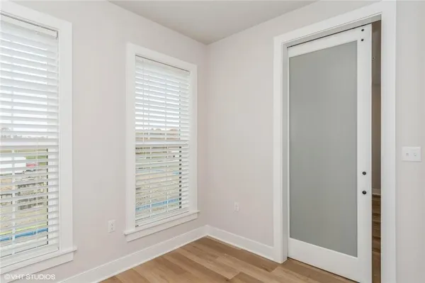 a view of a small space with wooden floor and a window