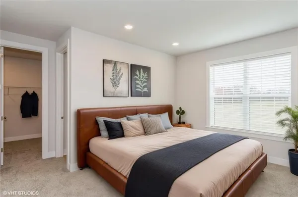 a bedroom with a large bed and a large window