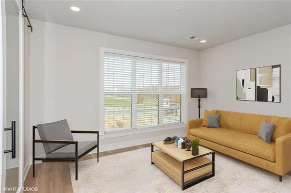 a living room with furniture and a large window