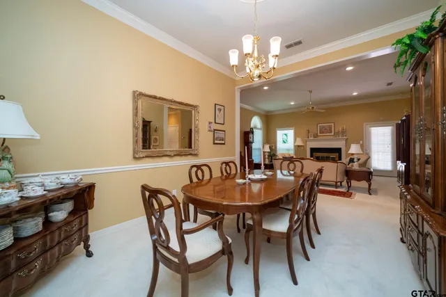 a view of a dining room with furniture and a chandelier