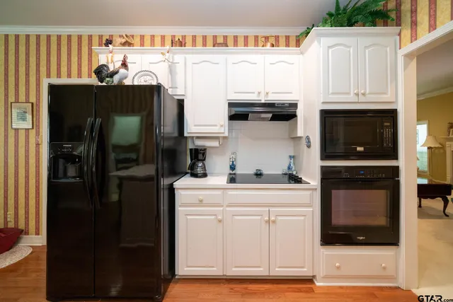 a kitchen with stainless steel appliances granite countertop a refrigerator stove and sink
