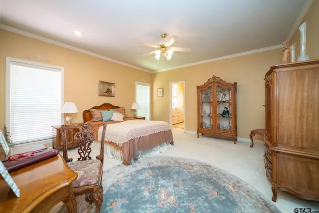 a spacious bedroom with a bed and a chandelier