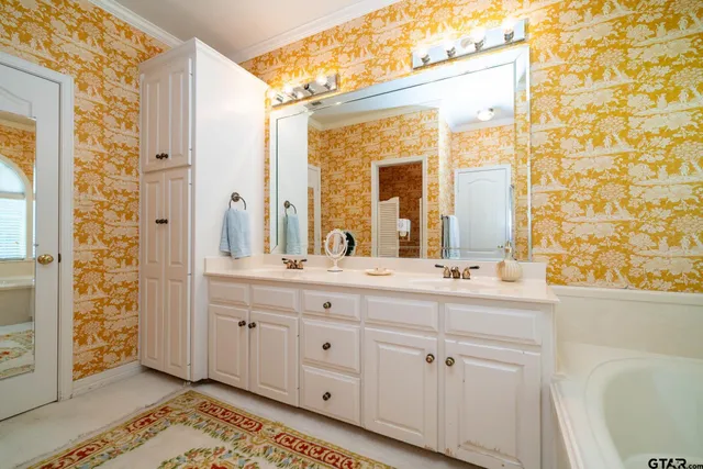 a bathroom with a double vanity sink mirror and