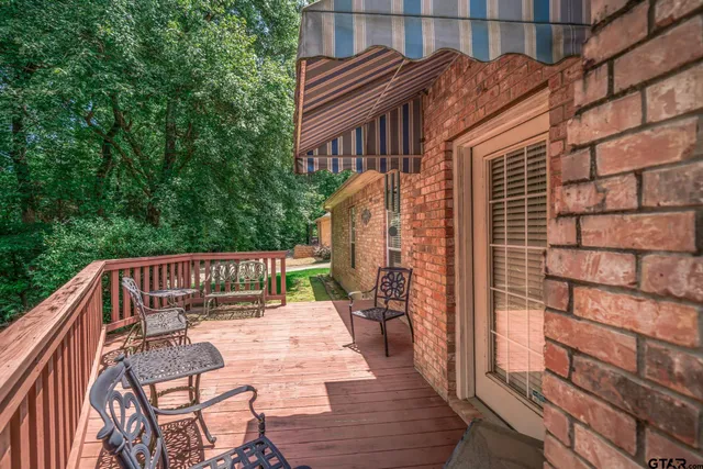 a view of balcony with wooden floor and outdoor seating