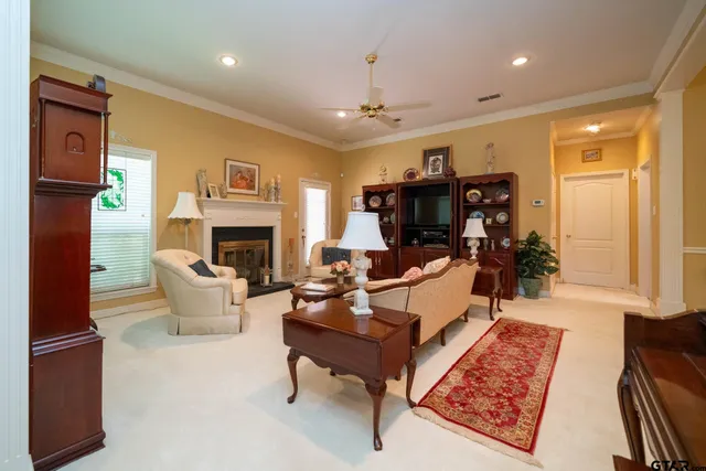 a living room with furniture fireplace and a table