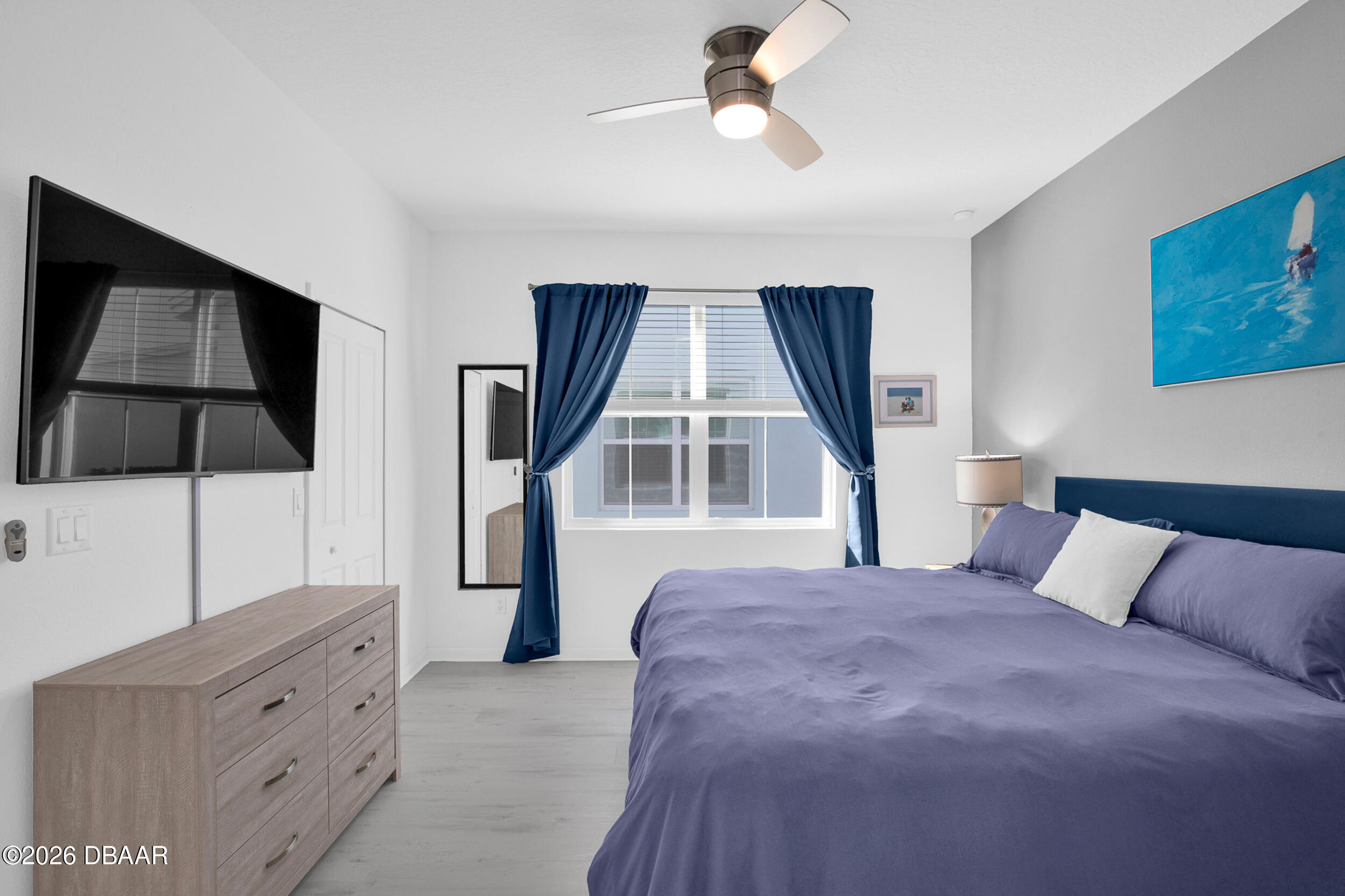 533 Margaritaville Avenue Daytona Beach, FL 32124 - Photo 12 of 43 a bedroom with a bed and a flat tv screen on the dresser