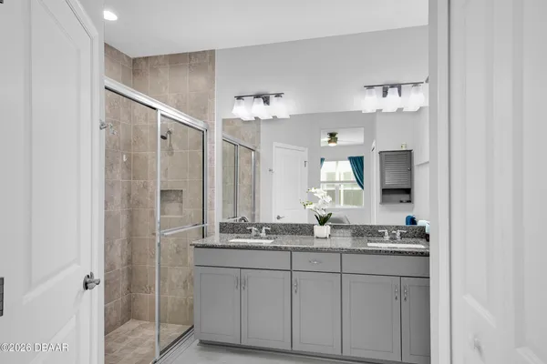 a bathroom with a shower and a sink