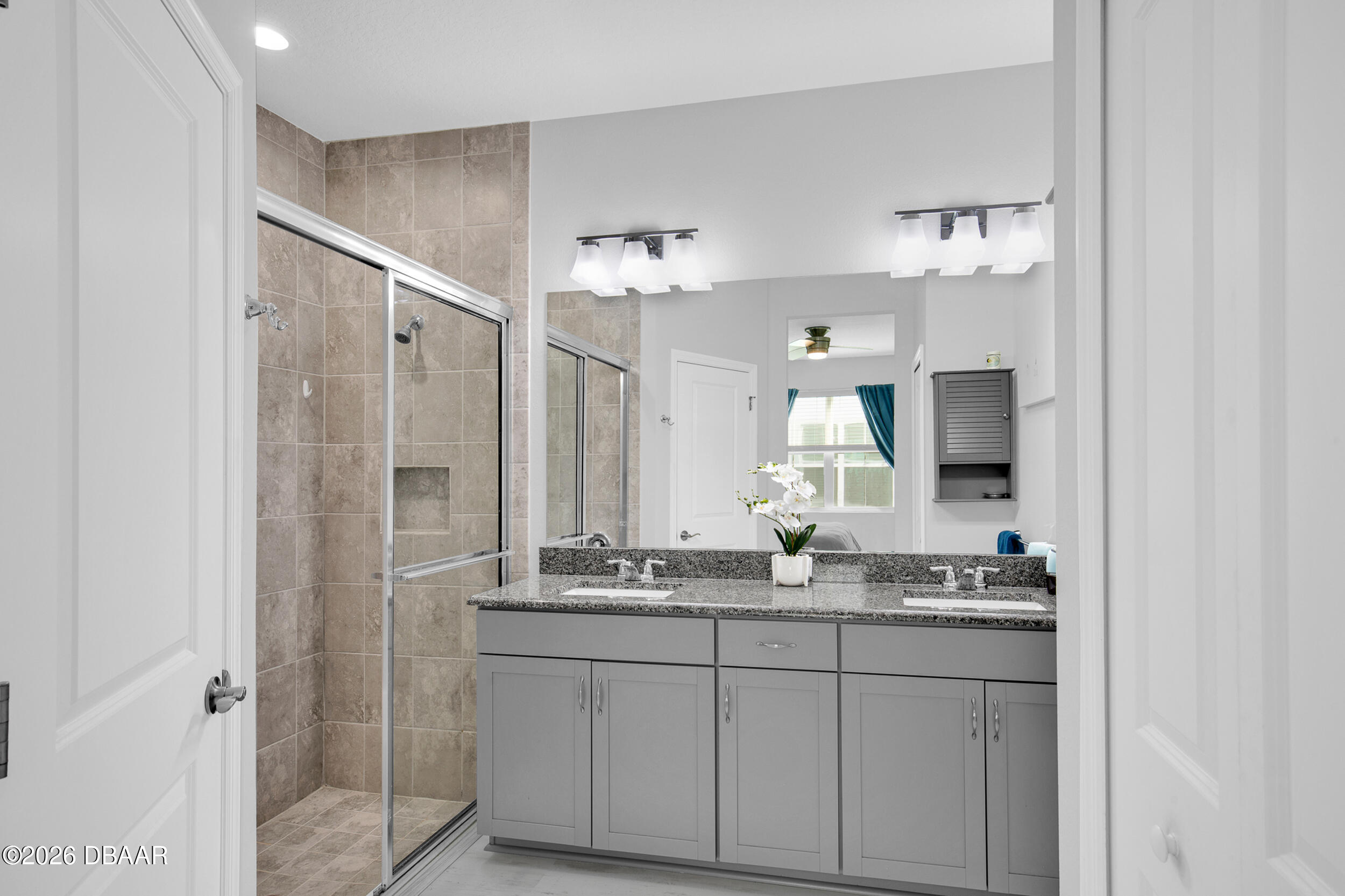 533 Margaritaville Avenue Daytona Beach, FL 32124 - Photo 13 of 43 a bathroom with a sink and a mirror