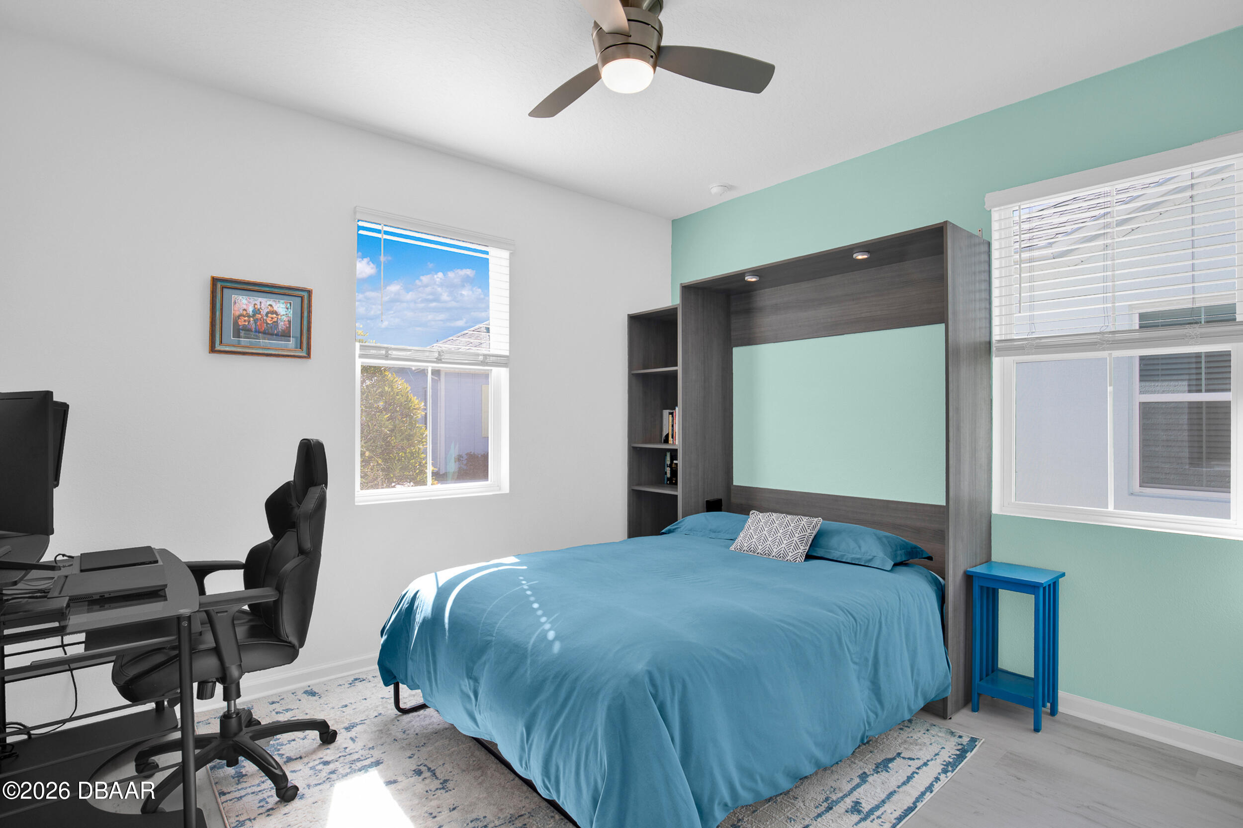 533 Margaritaville Avenue Daytona Beach, FL 32124 - Photo 15 of 43 a bedroom with a bed large window and chair