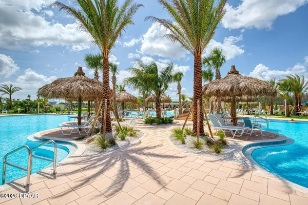 a view of a patio with table and chairs potted plants
