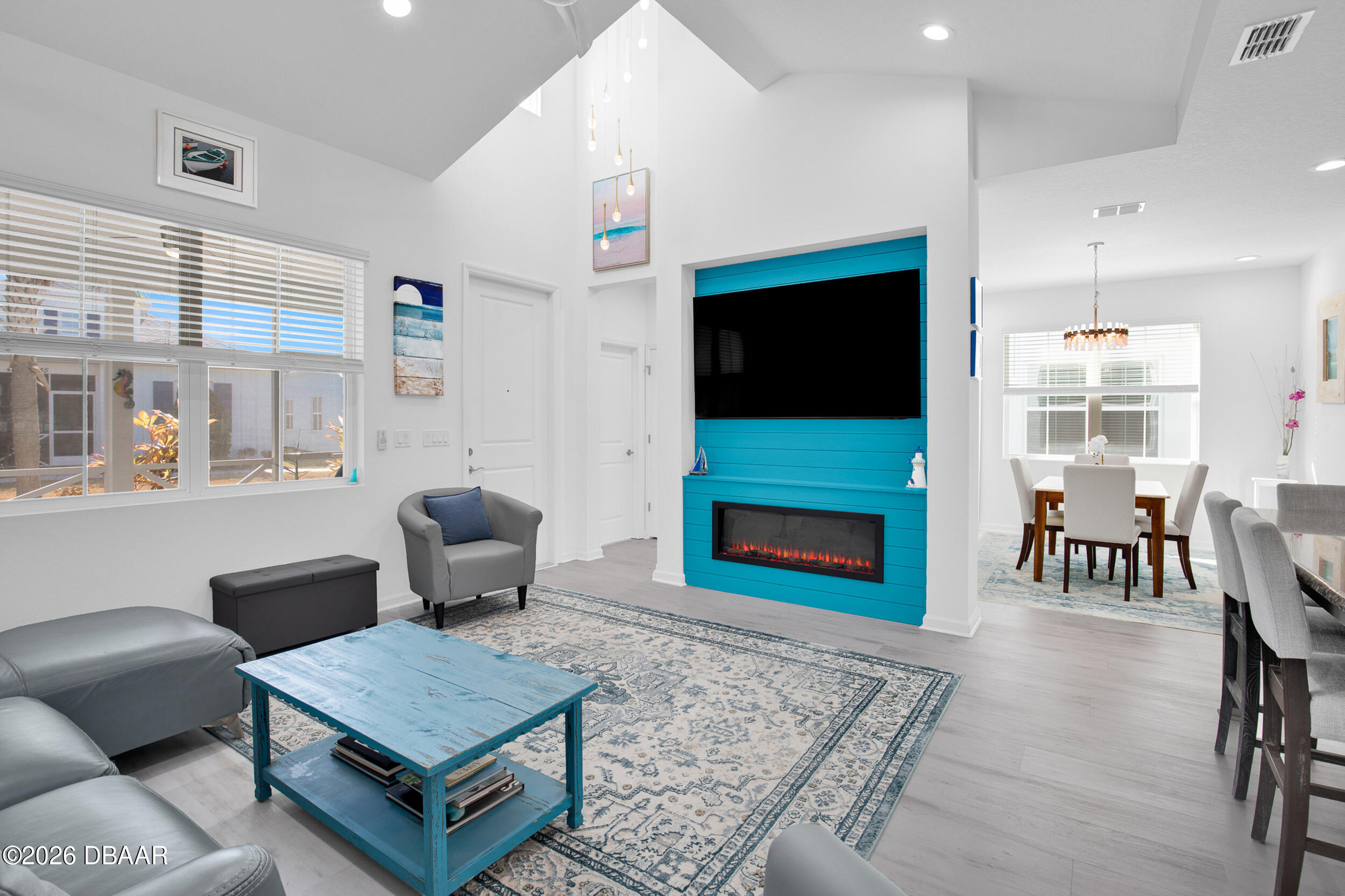 533 Margaritaville Avenue Daytona Beach, FL 32124 - Photo 4 of 43 a living room with furniture a flat screen tv and a fireplace