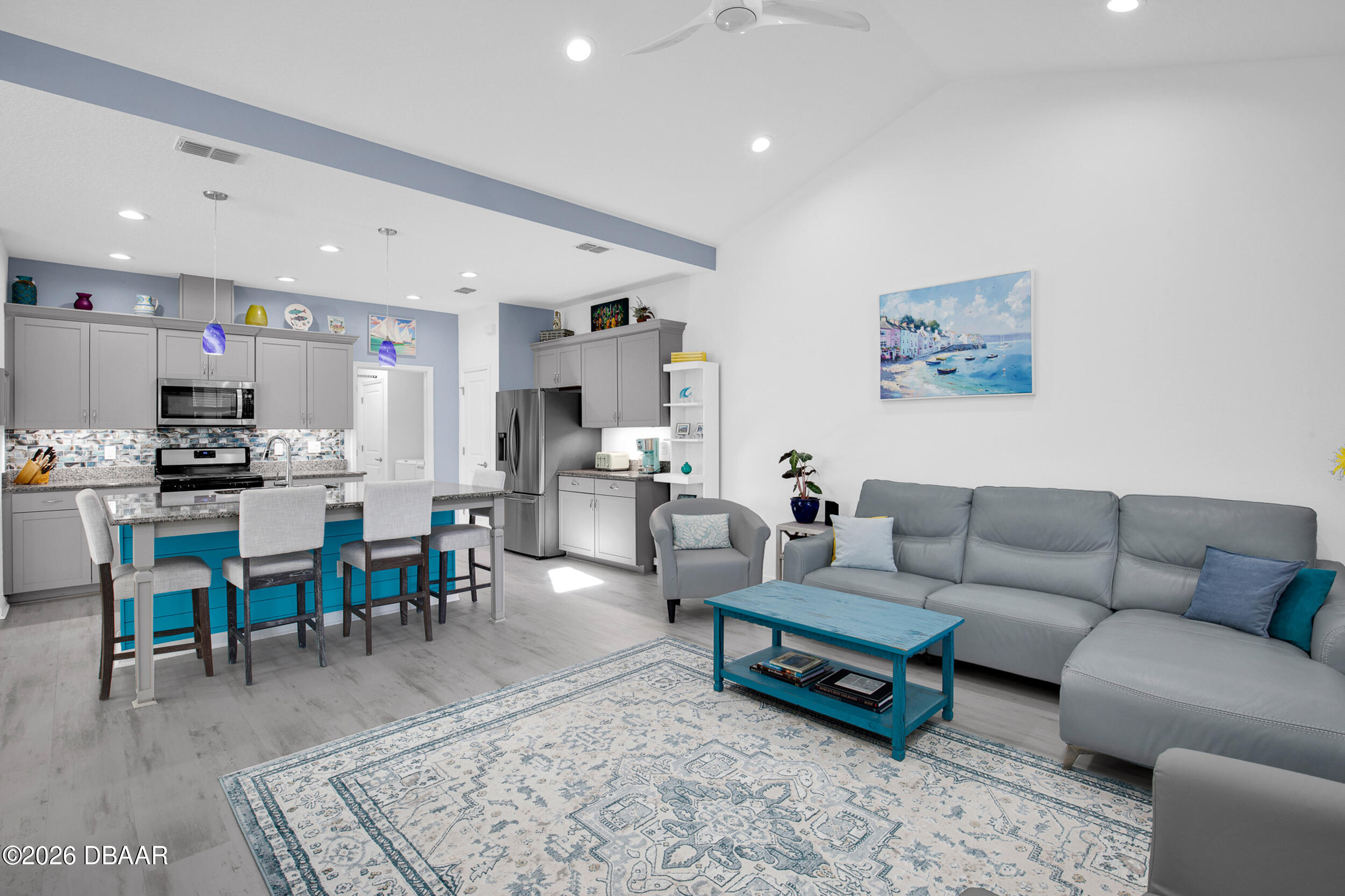 533 Margaritaville Avenue Daytona Beach, FL 32124 - Photo 5 of 43 a living room with furniture kitchen view and a dining table