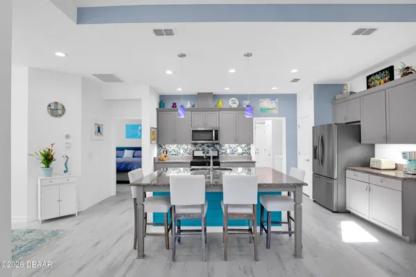 a kitchen with granite countertop a sink and stainless steel appliances