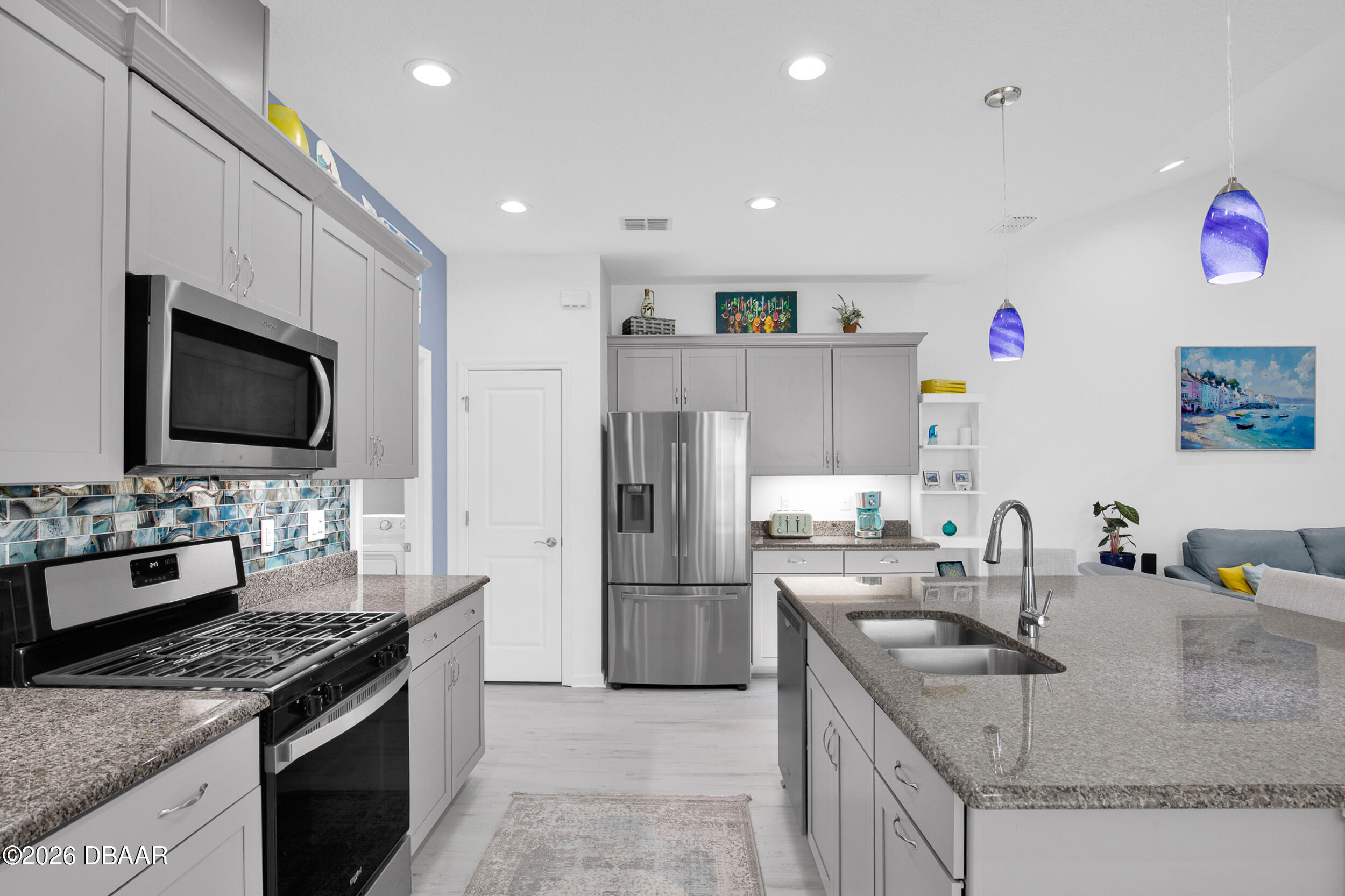 533 Margaritaville Avenue Daytona Beach, FL 32124 - Photo 7 of 43 a kitchen with granite countertop a sink and stainless steel appliances