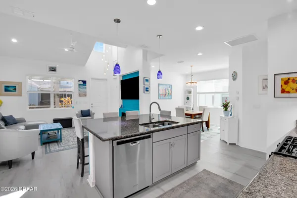 a dining room with furniture potted plants and wooden floor