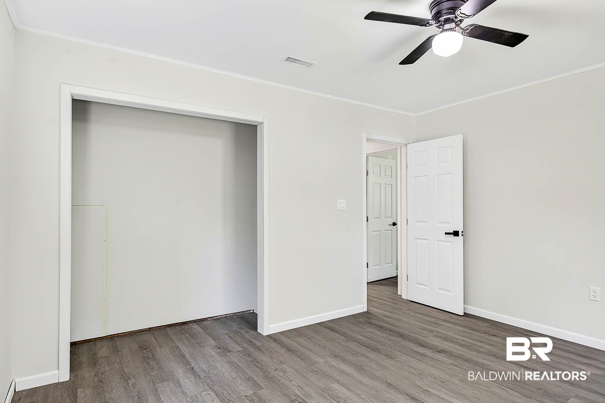 101 Terry Avenue Brewton, AL 36426 - Photo 48 of 48 Unfurnished bedroom with crown molding, wood finished floors, a closet, and ceiling fan