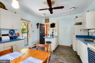 41 Cornhill Street Annapolis, MD 21401 - Photo 14 of 36 a kitchen with stainless steel appliances kitchen island granite countertop a refrigerator and a sink
