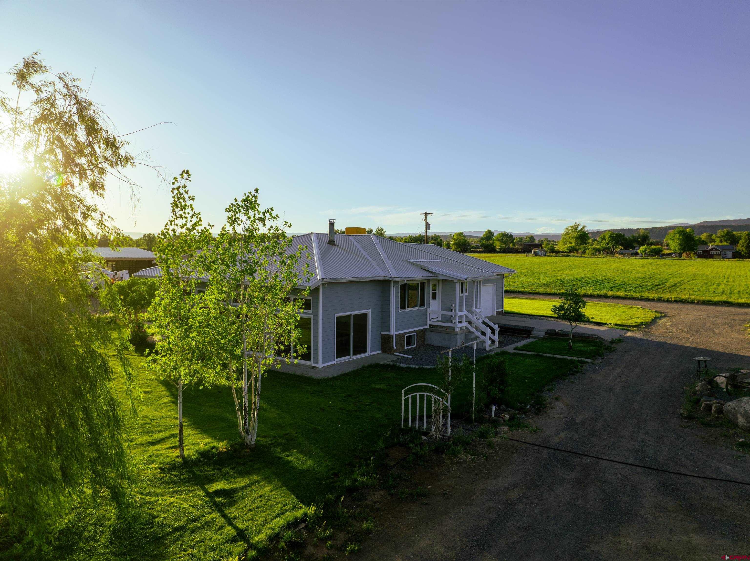 9627 3200th Road Hotchkiss, CO 81419 - Photo 1 of 44 a view of a house with a yard