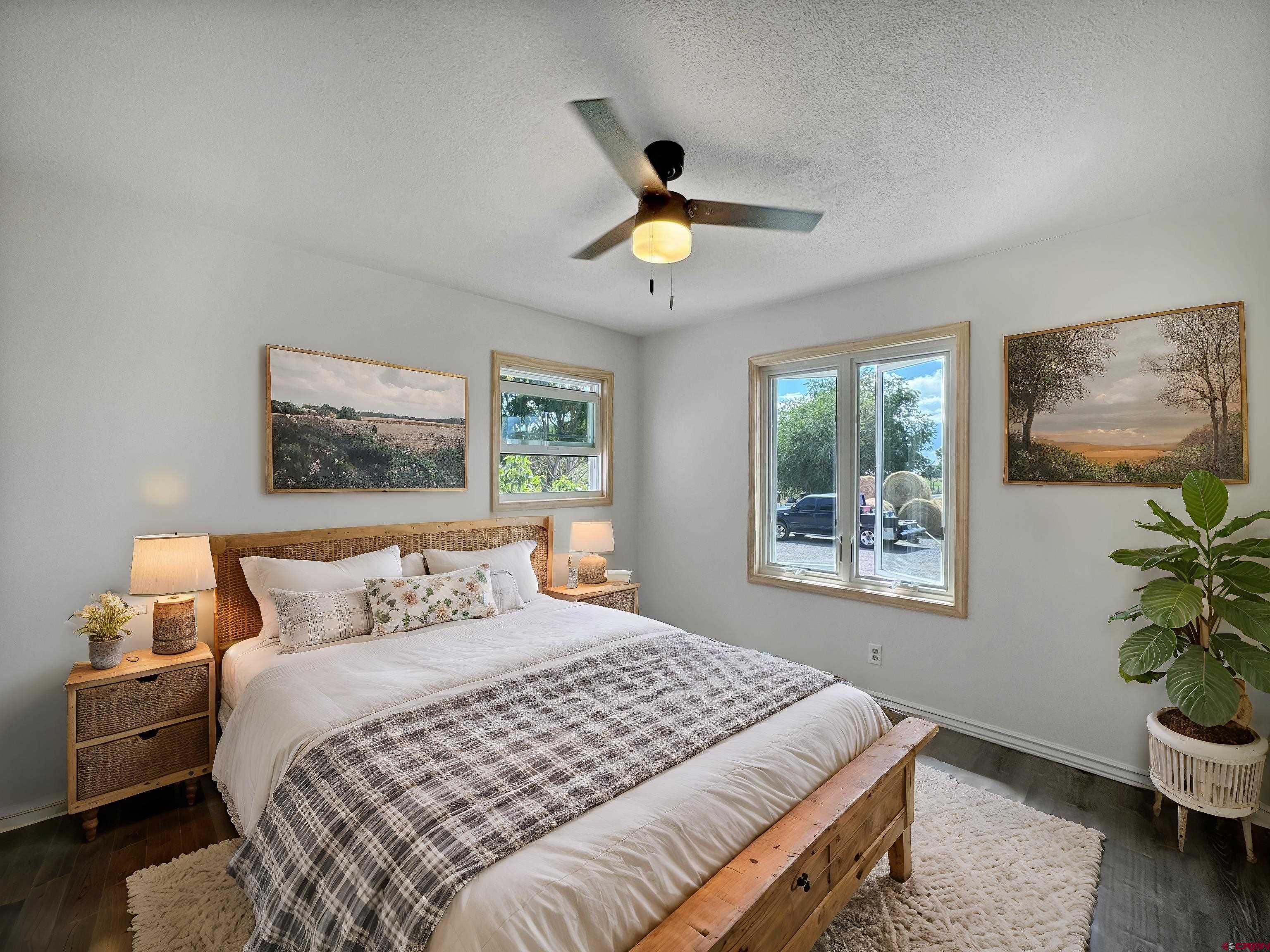 9627 3200th Road Hotchkiss, CO 81419 - Photo 27 of 44 a bedroom with a bed and a painting on the wall