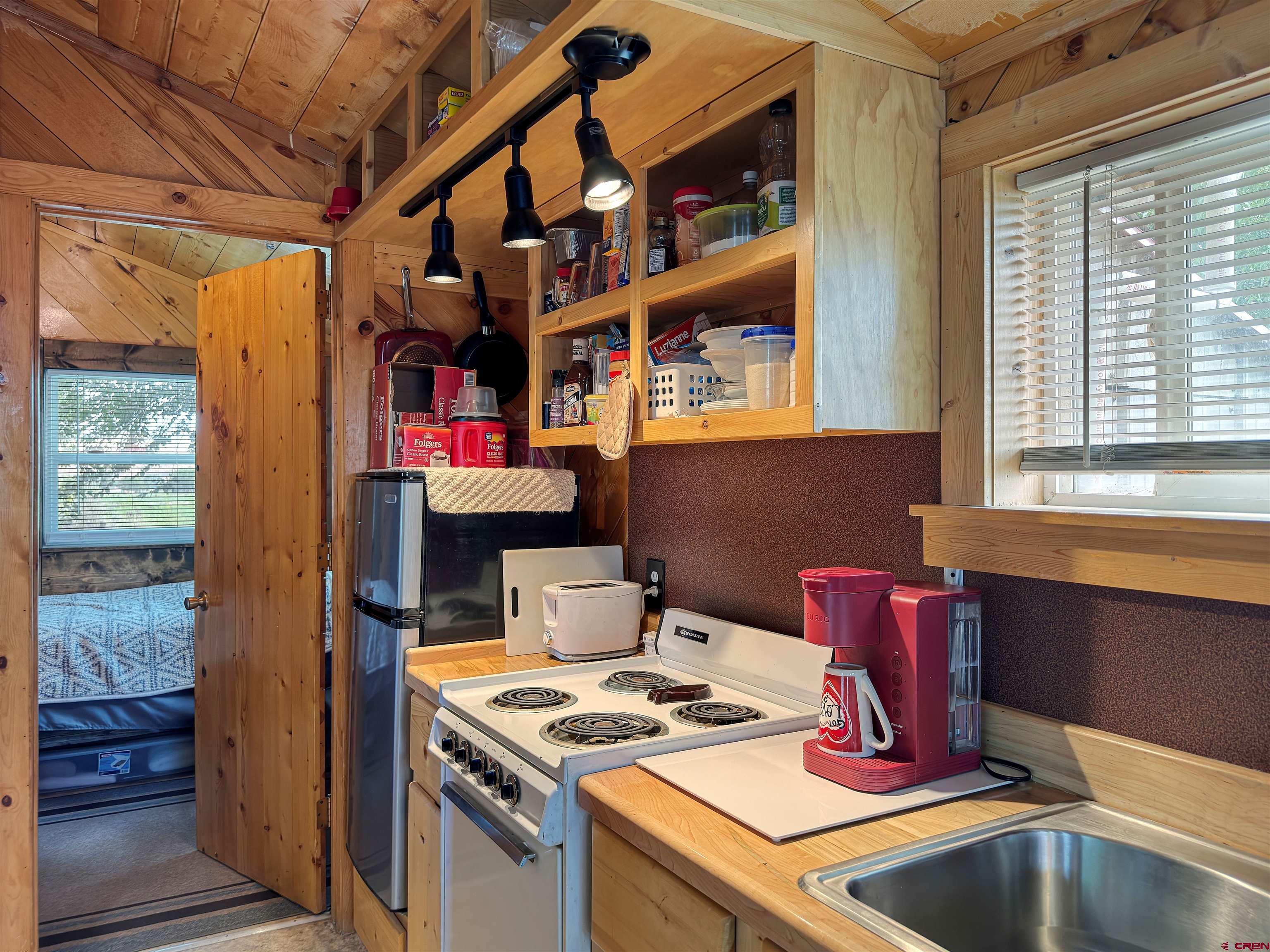9627 3200th Road Hotchkiss, CO 81419 - Photo 32 of 44 a kitchen with a stove and a microwave