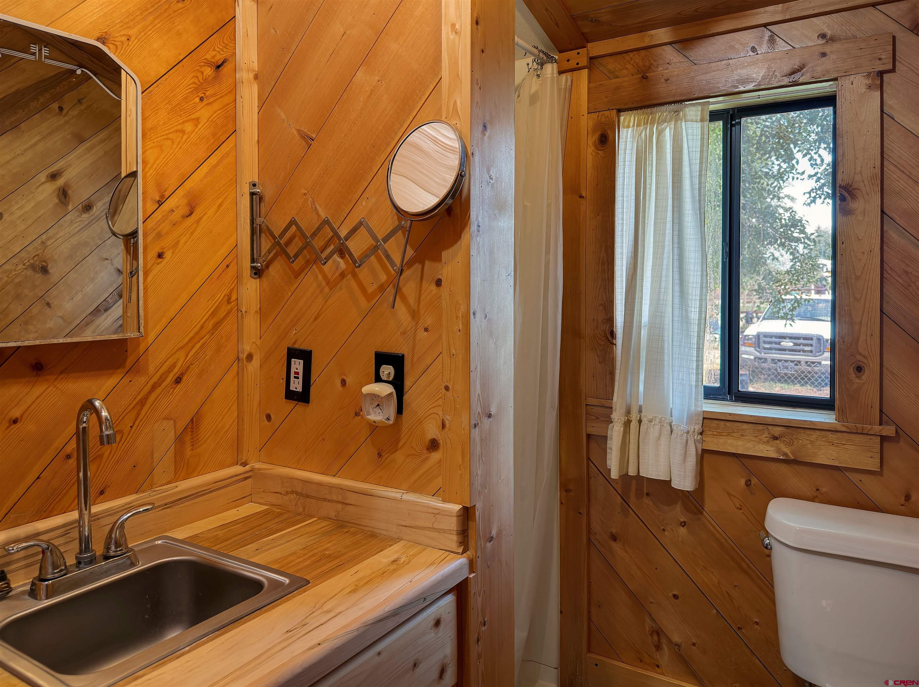 9627 3200th Road Hotchkiss, CO 81419 - Photo 33 of 44 a bathroom with a sink and a window