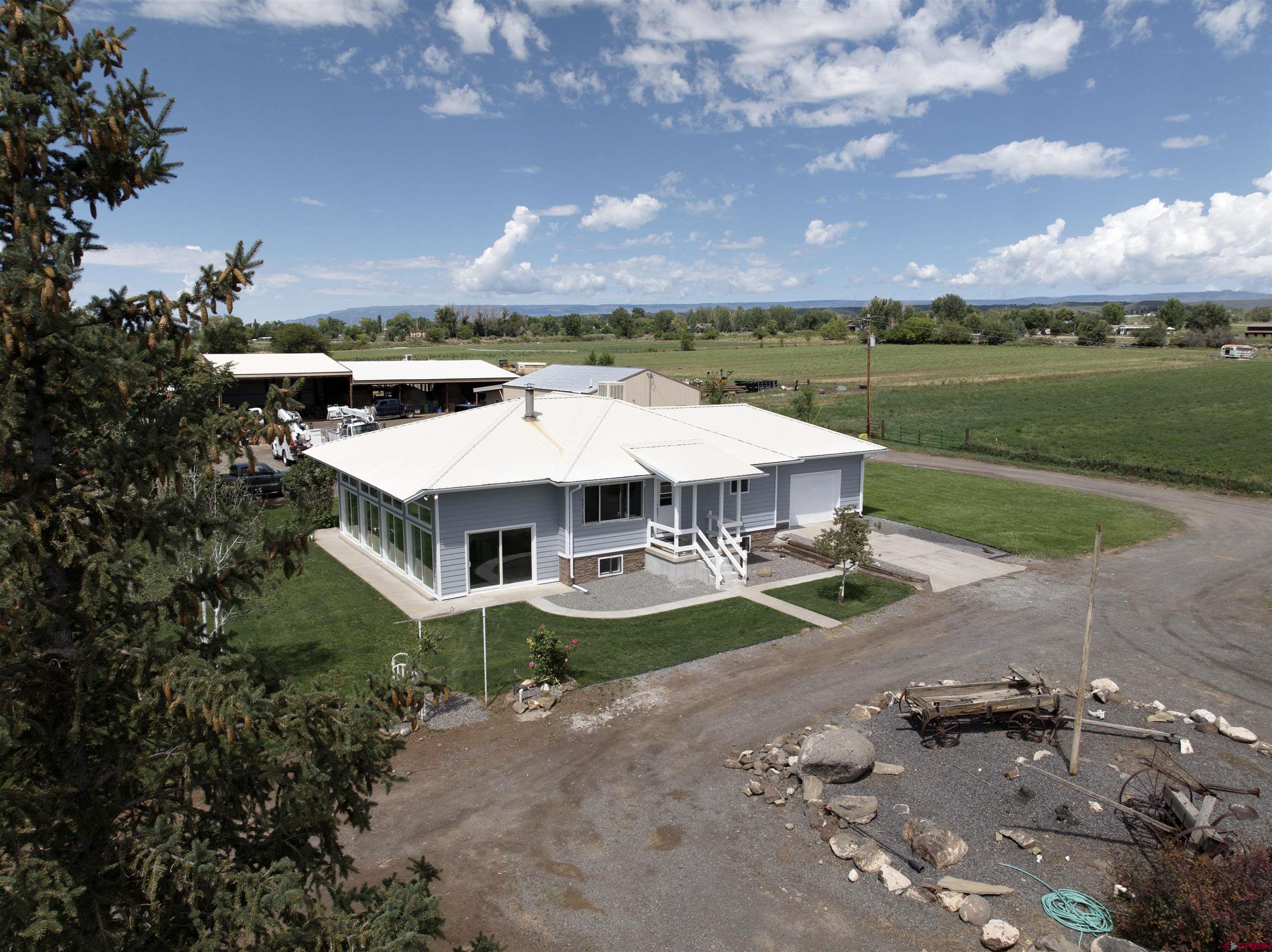 9627 3200th Road Hotchkiss, CO 81419 - Photo 6 of 44 an aerial view of a house with a garden and lake view